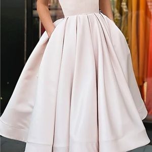 Beautiful ivory satin strapless full pleated skirt gown. Below the knee.